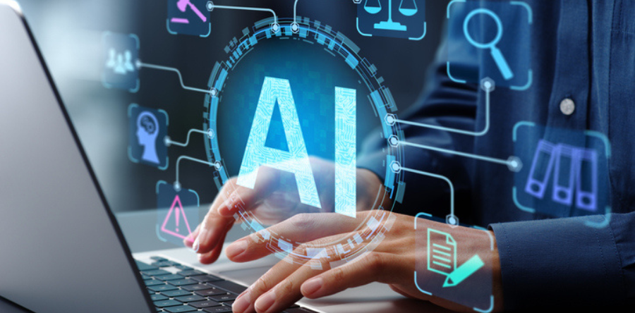 Businessman typing on laptop computer keyboard at desk in office.