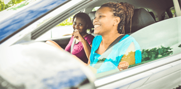 Image of two women driving and talking in a car