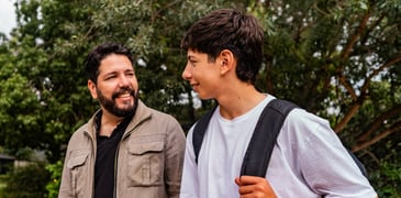 Father and son having a conversation in the park.