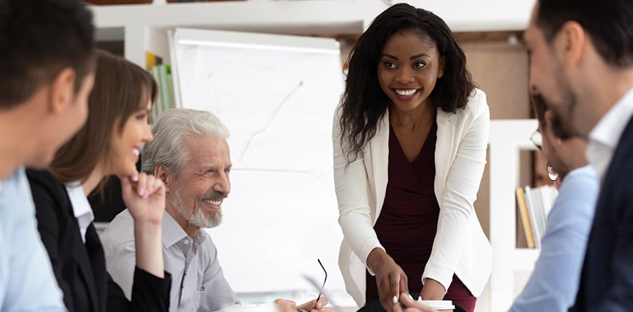 Image of woman presenting to colleagues during meeting.