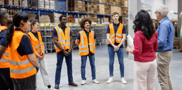 Young workers receiving training in a warehouse.