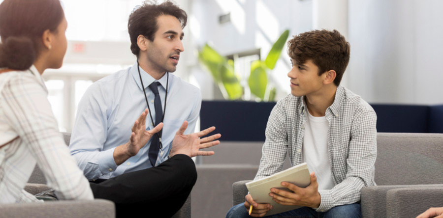 Image of a supervisor speaking with young workers