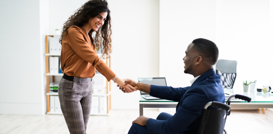 Image of coworkers shaking hands in an office