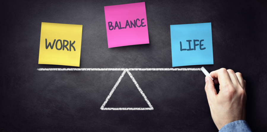 Image of post it notes labeled work, life, balance placed on black board 