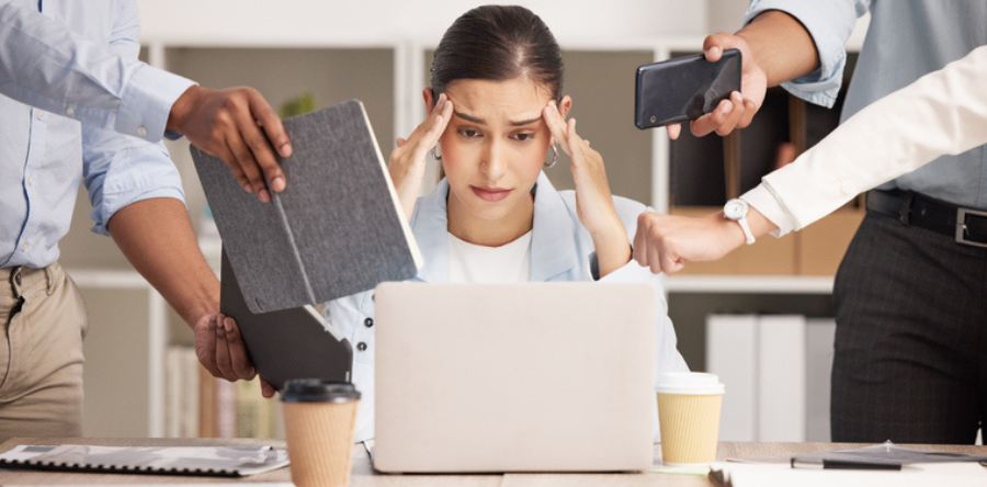 Image of a business woman with headache from workload and laptop deadline in office