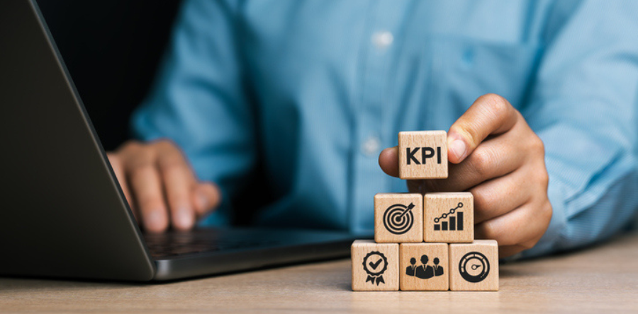 Image of business person stacking KPI blocks