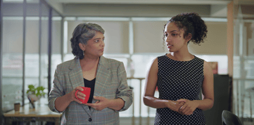 Young worker talking to her boss.