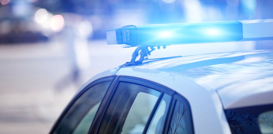 Image showing white top of a police cruiser with a flashing blue light 