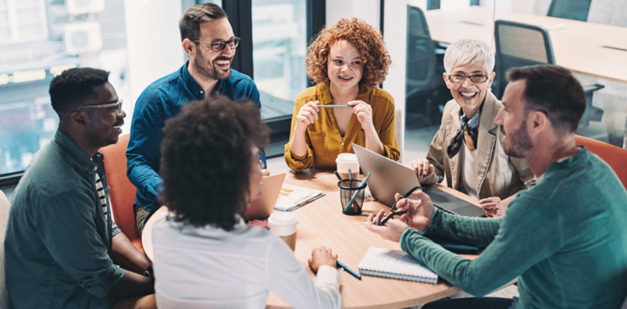 A group of people sitting around a table having a conversation