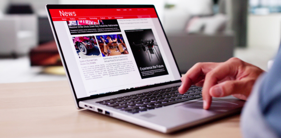 Watching News On Screen. Reading Newspaper Website On Laptop