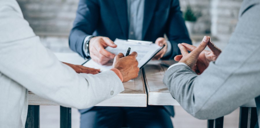 Image of office workers discussing and taking notes during a meeting