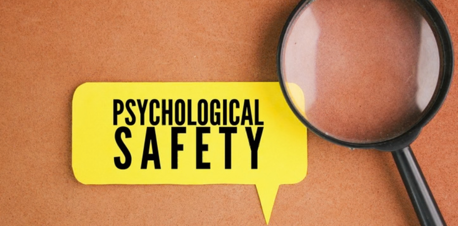 Psychologigal safety written in a yellow bubble with a magnify glass