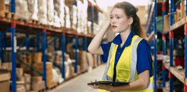 Image of a woman standing in a warehouse aisle 