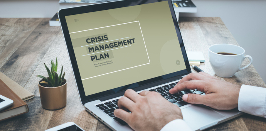 Image of crisis management plan written on laptop screen 