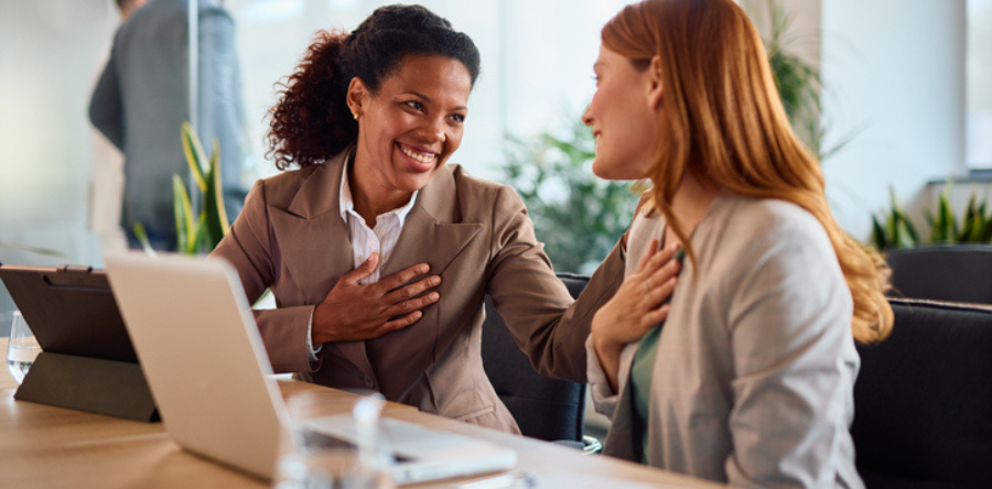 Image of coworkers talking and supporting each other