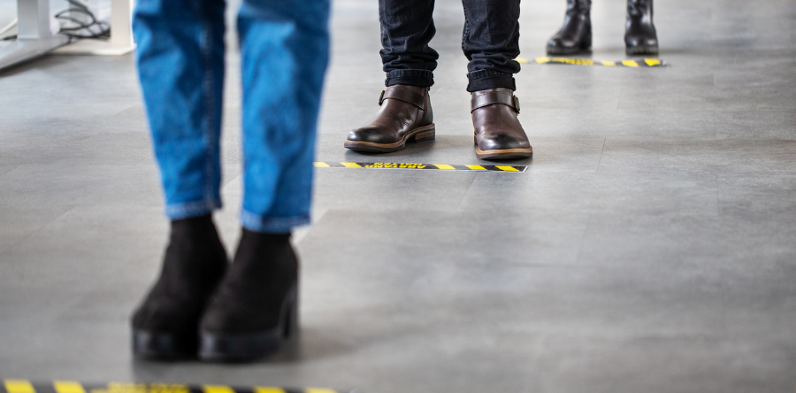 Image of people standing in a line at designated lines