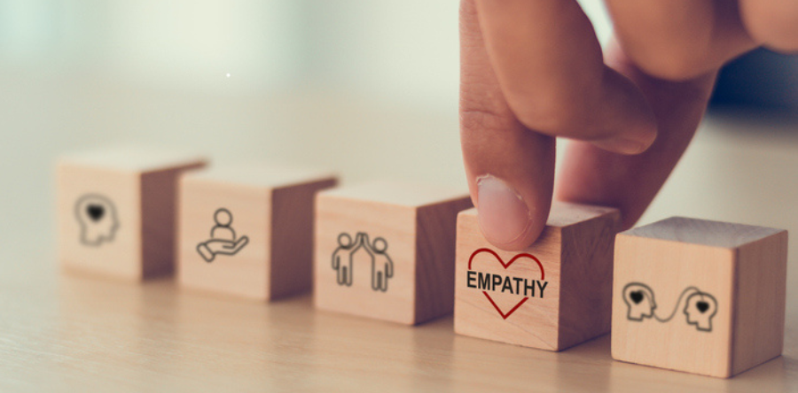 Image of wooden blocks with empathy icons 