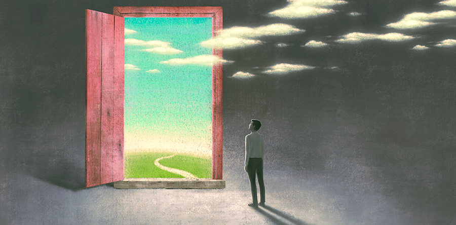 Image of a man standing in a dark room looking out a wooden door at road with grass on each side and lue sky with white clouds